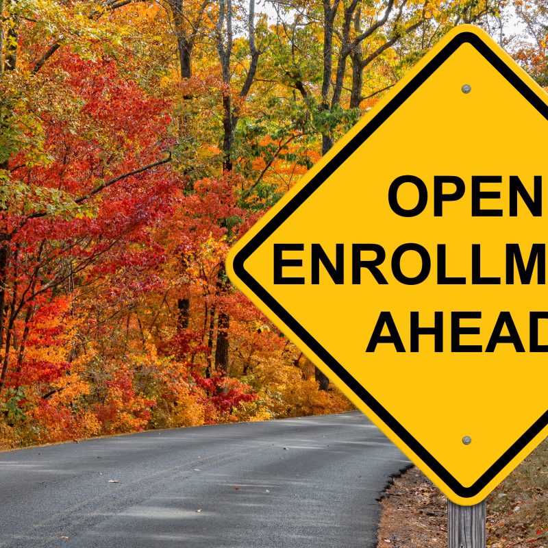 Open Enrollment Caution Sign With Autumn Road Background